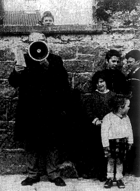 Youthful audience watches Bart Gormley of Tuam read the Roll of Honour at the Workhouse Commemoration.