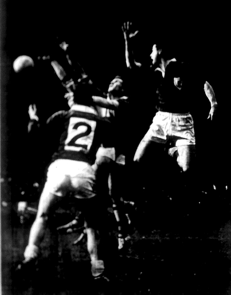 This ball [awaits] the hands of Mick O'Dwyer and Pat Griffin (Kerry) and Martin Newell (Galway) on left. Galway captain, Enda Colleran (2) is ready to avert danger.